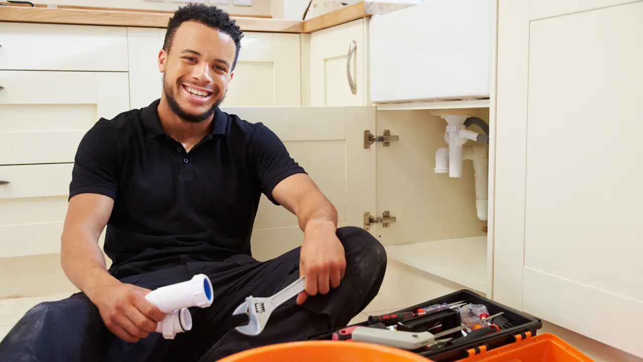 A Precision Plumbing technician answering customer questions